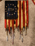 Wooden flag with '1776' on a textured surface